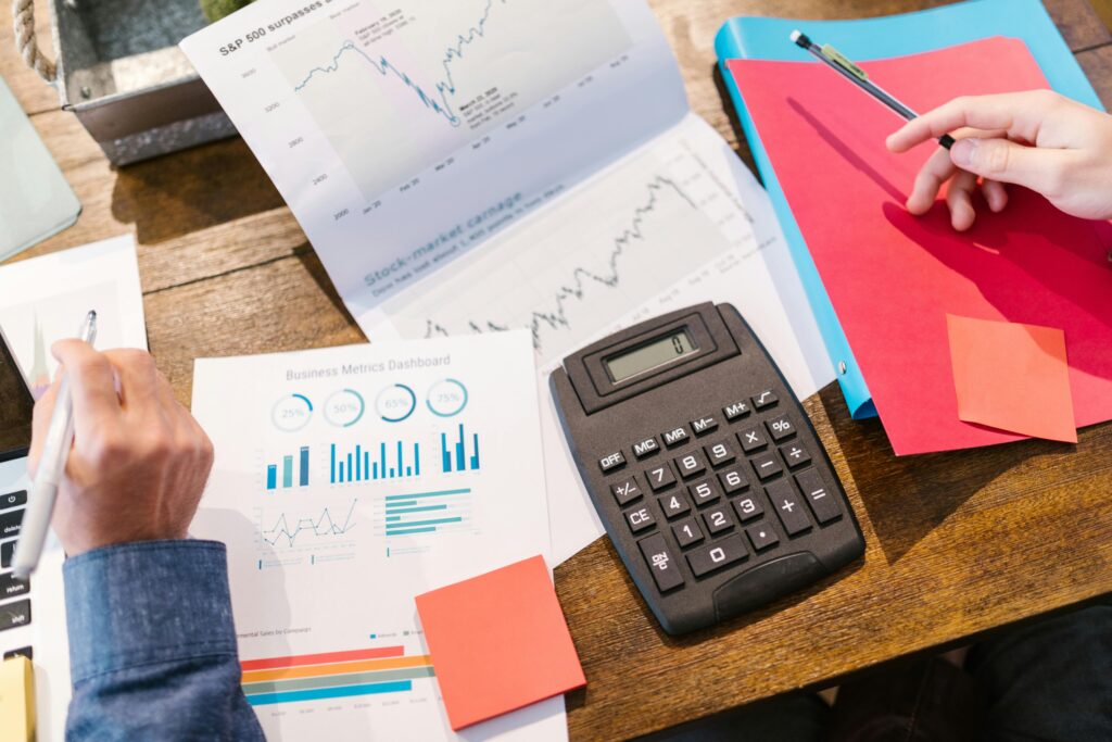 Financial analysis and planning tools with graphs and calculator on a table.