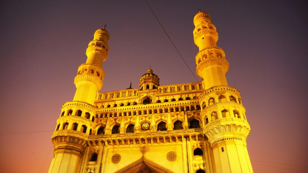 Stunning low angle view of Charminar at twilight showcasing its historical architecture.